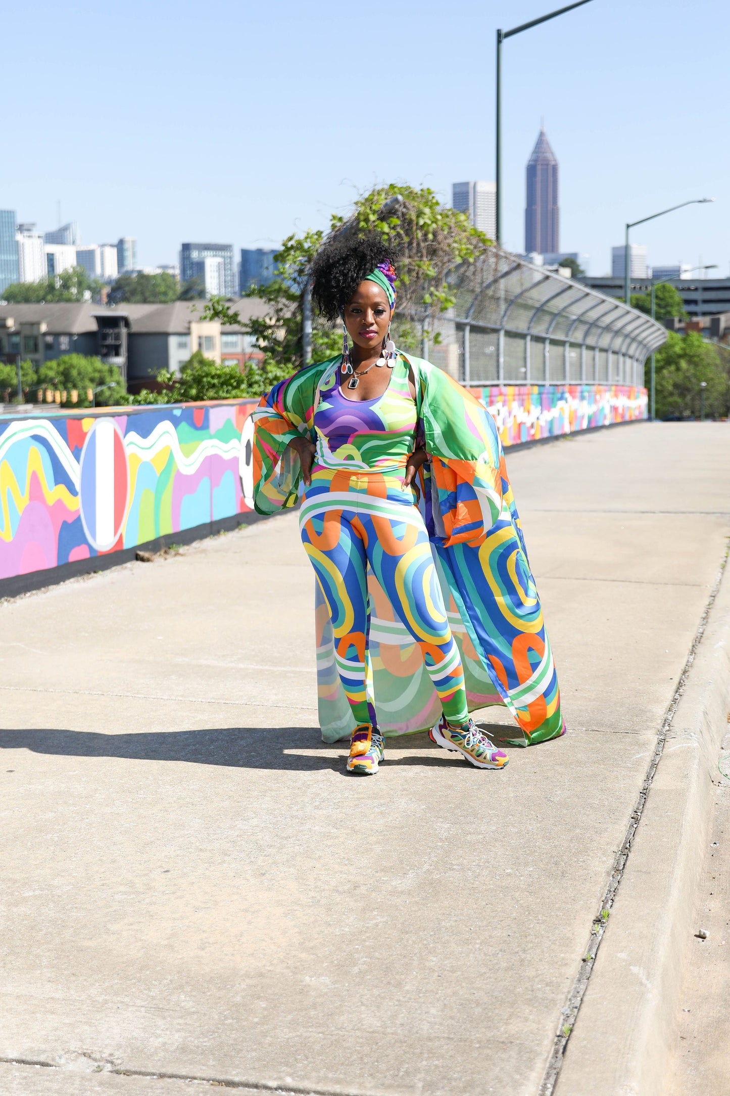 Melissa A. Mitchell standing in front of Trefoil Trail, her 10,000-square-foot mural celebrating the 2026 FIFA World Cup in Atlanta.